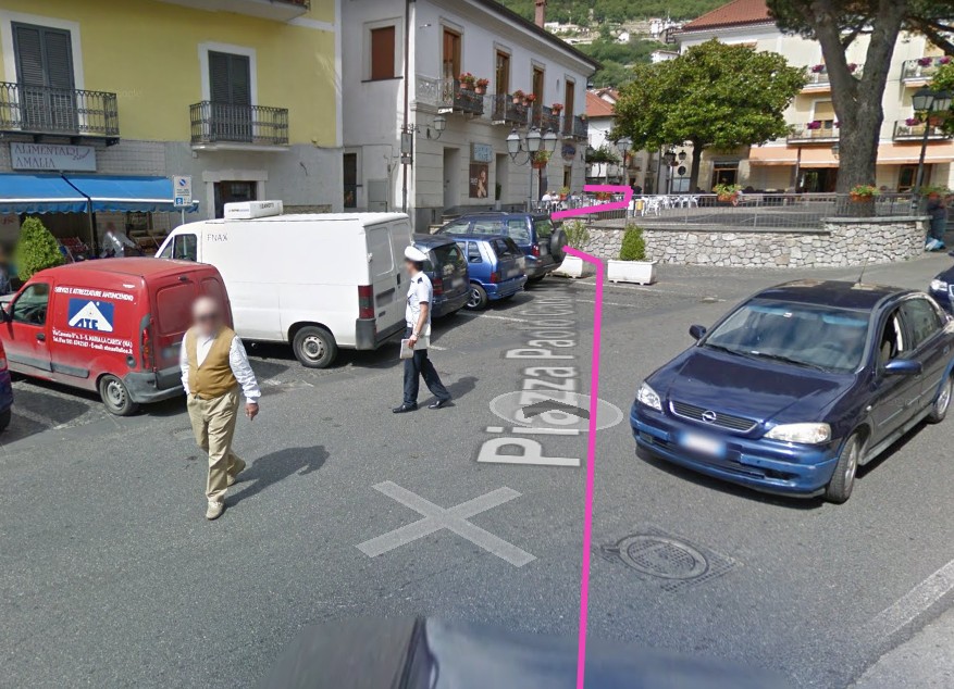 Town square (piazza) in Bomerano with left-hand route markers