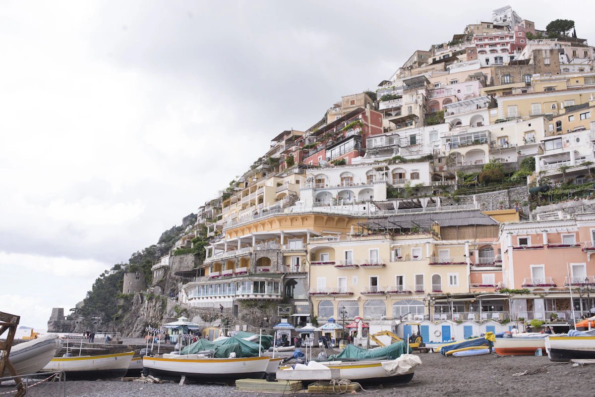 Fornillo beach in Positano with clear water and a few boats.