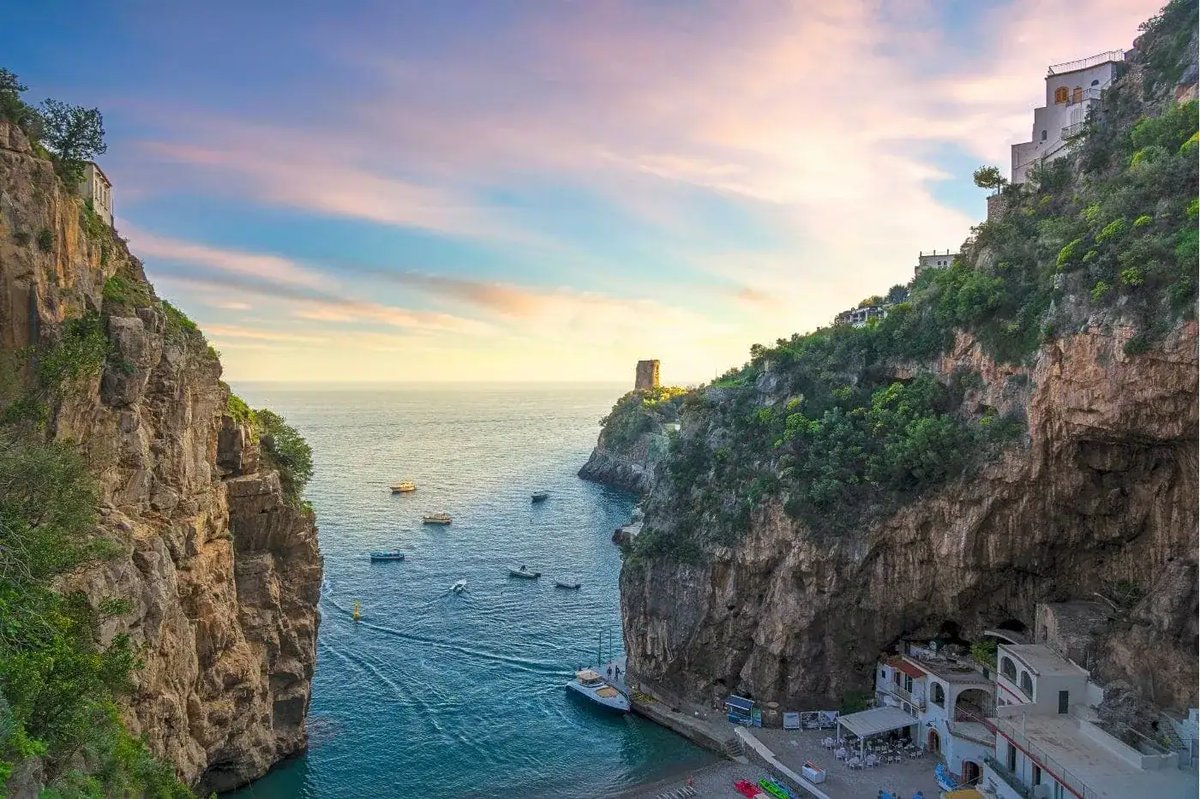 Marina di Praia cove at sunset — dramatic cliffs and clear water between Positano and Amalfi.