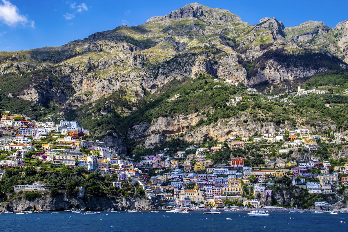 Sunset over Positano with warm light on the cliff face
