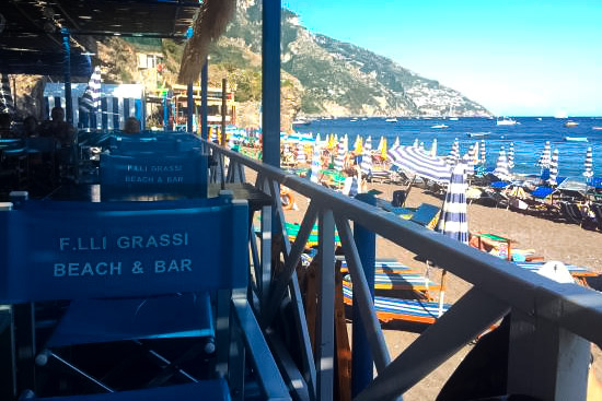 La Marinella beach club with loungers and restaurant near Spiaggia Grande walkway