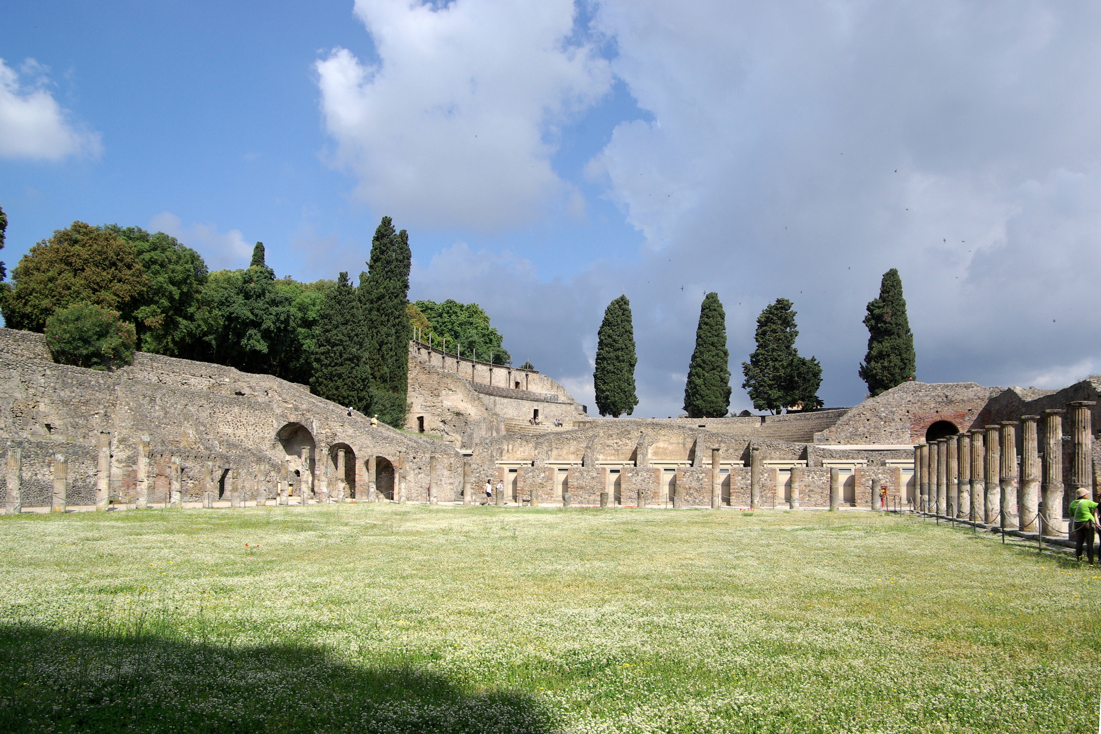 Tourists exploring Pompeii ruins on summer day
