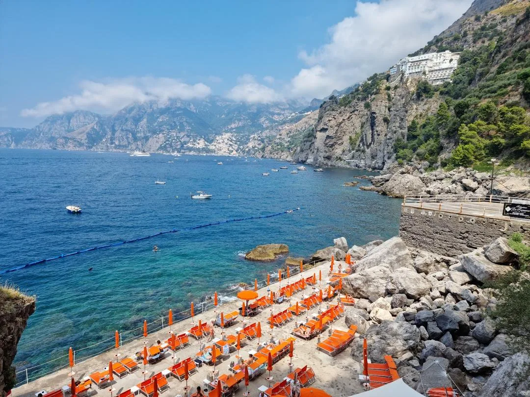 View of Gavitella Beach in Praiano with cliffside platforms and the sea